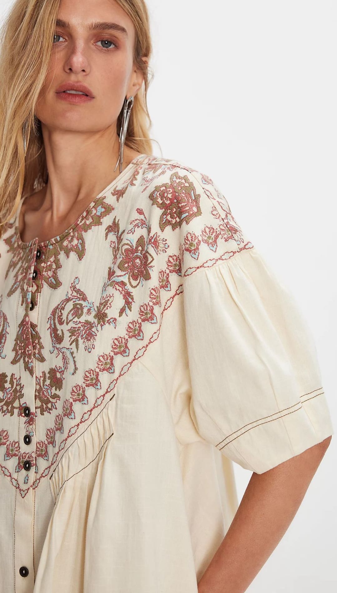 Embroidered cream-colored blouse.