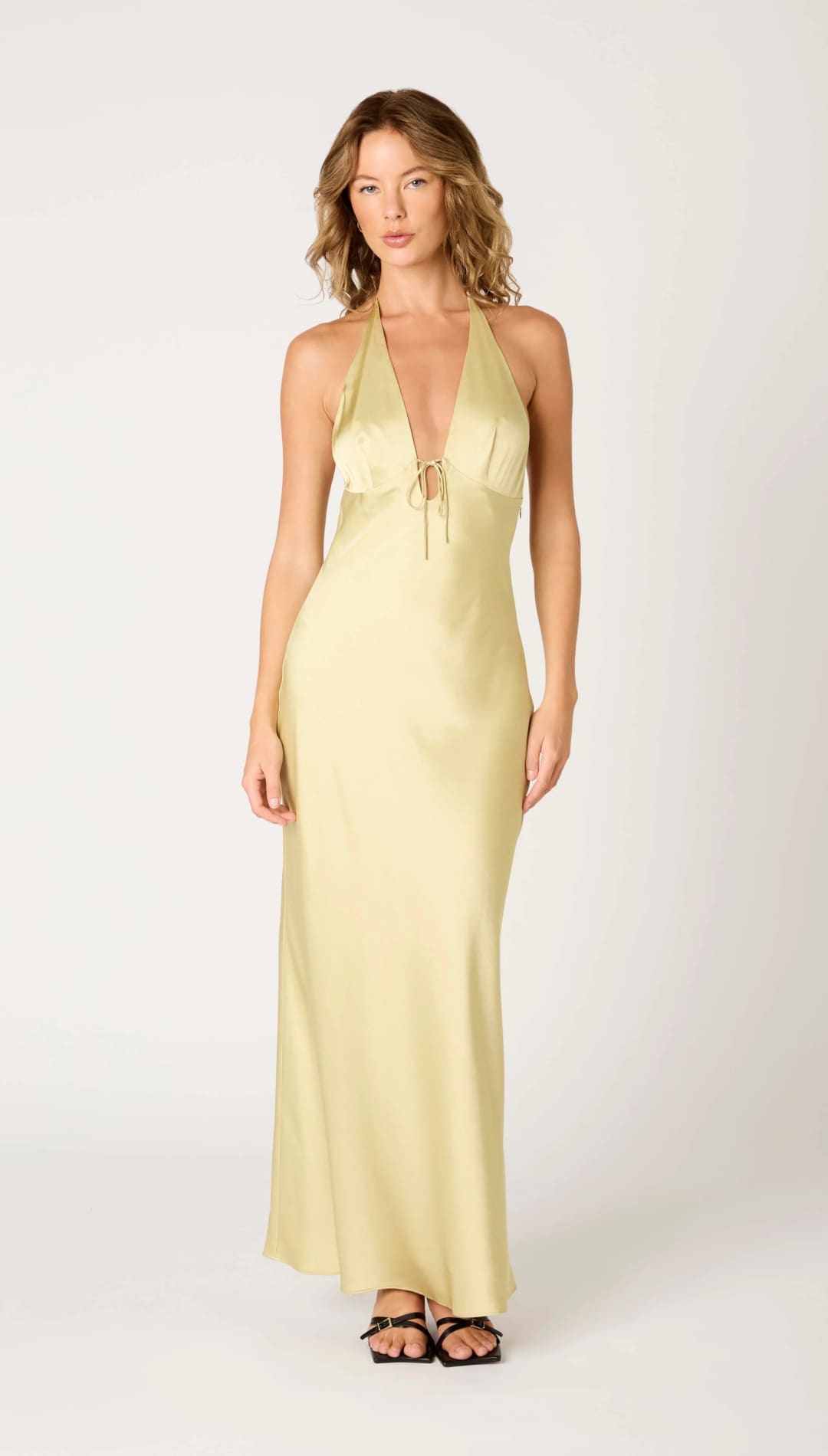 Sleeveless yellow halter dress.