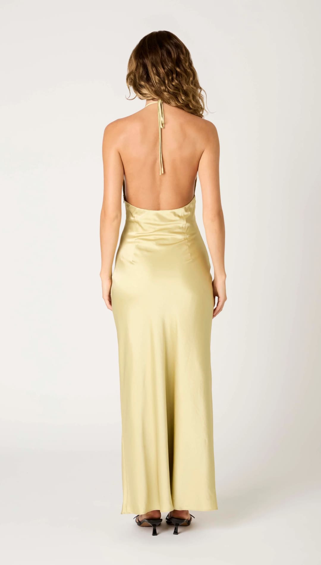 Back view of a yellow halter dress.