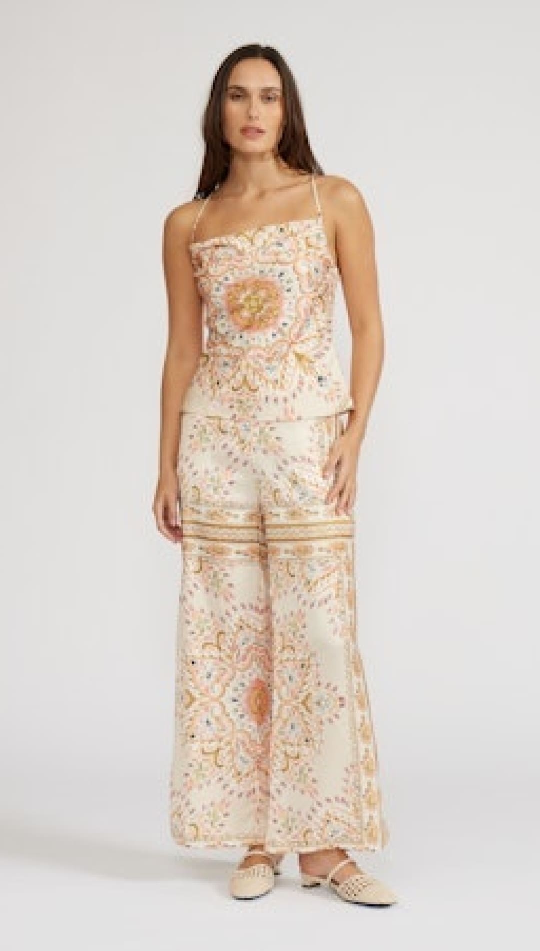 Woman wearing a patterned two-piece outfit.