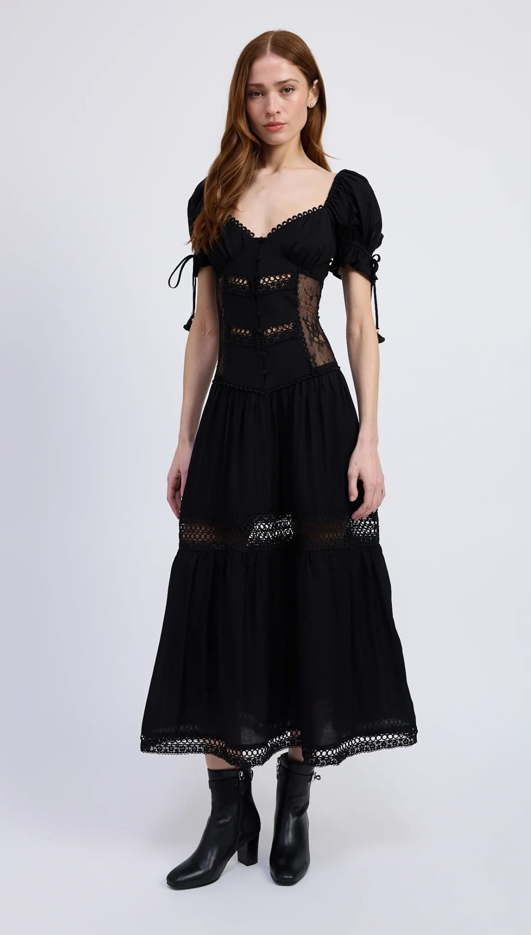 Black tiered midi dress with puff sleeves and lace inserts.