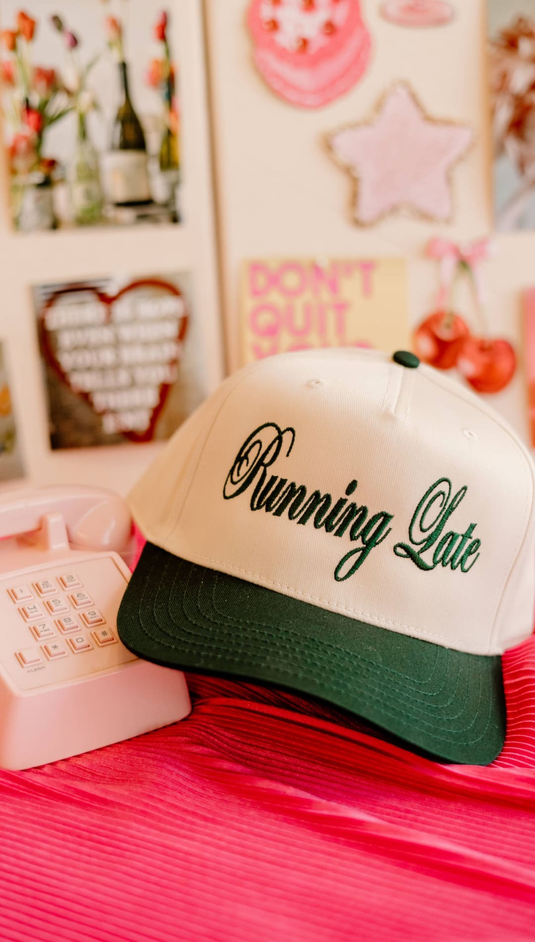 White and green ’running late’ trucker hat with black script.