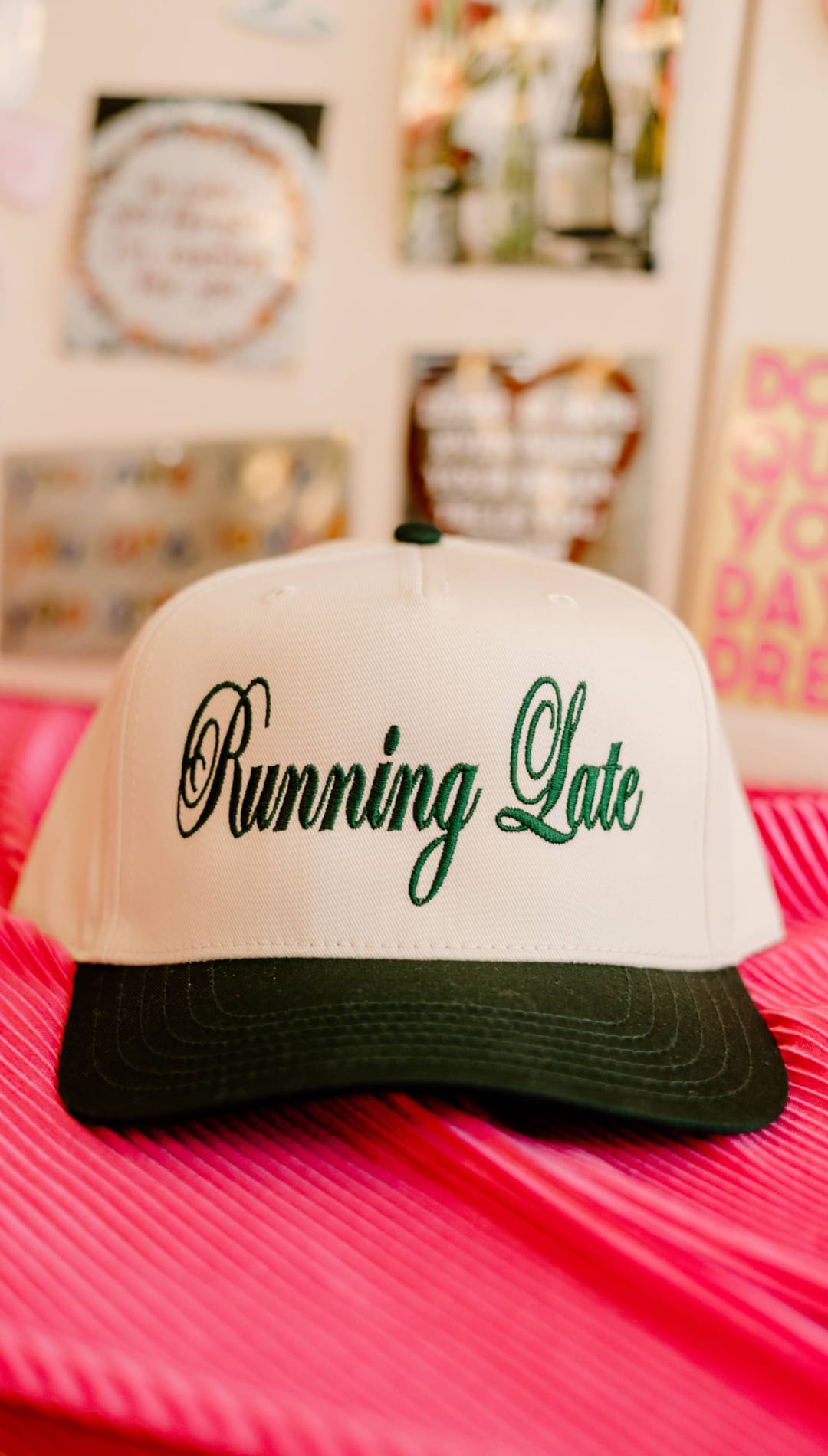 White and green ’running late’ trucker hat with black brim.