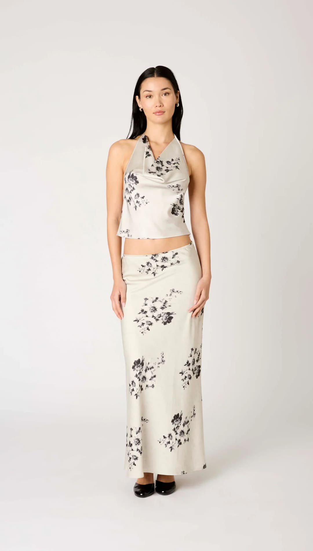 White floral print maxi skirt with black accents and a halter neck top set.