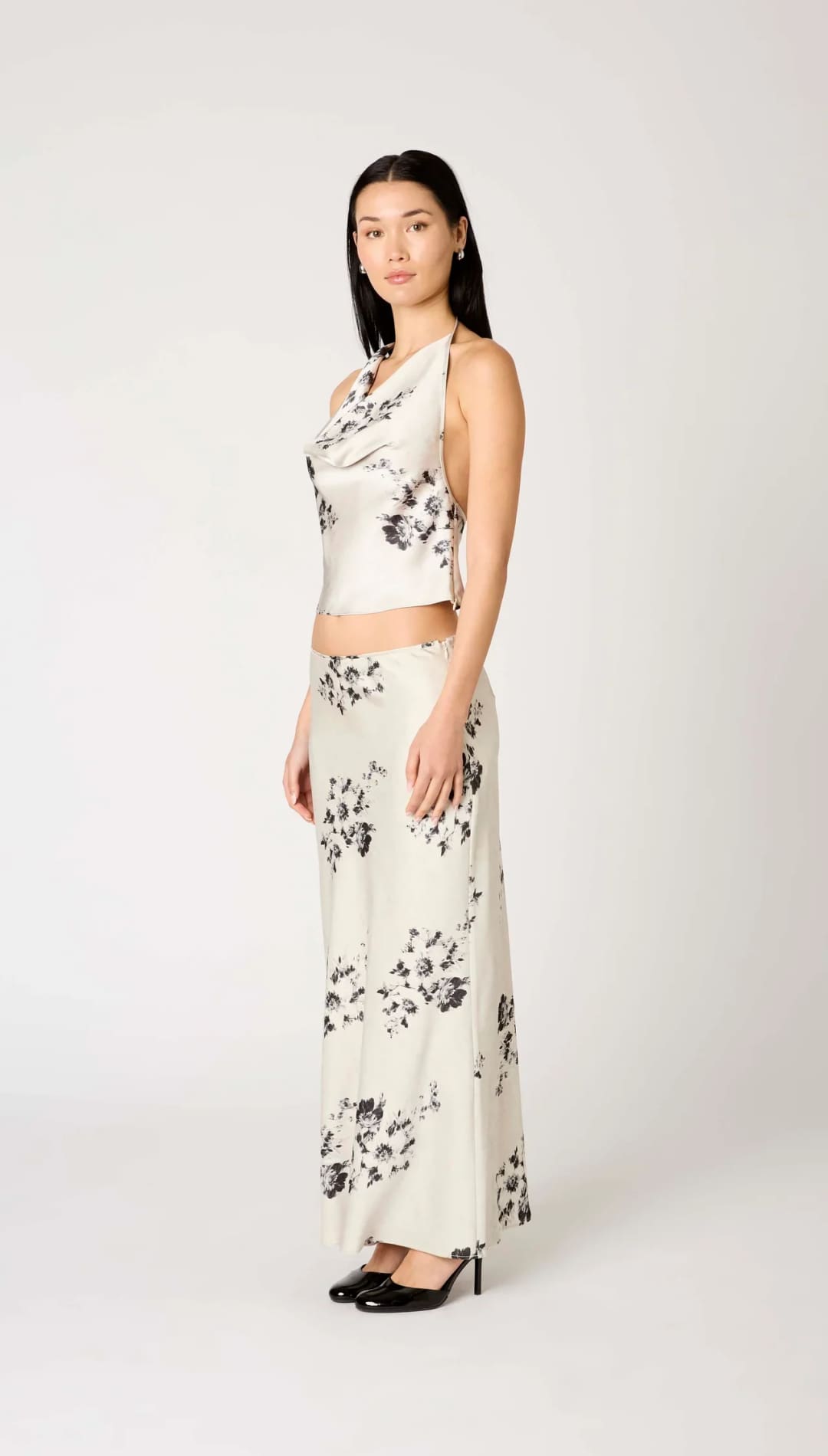 White floral print maxi skirt with black accents and high-waisted design.