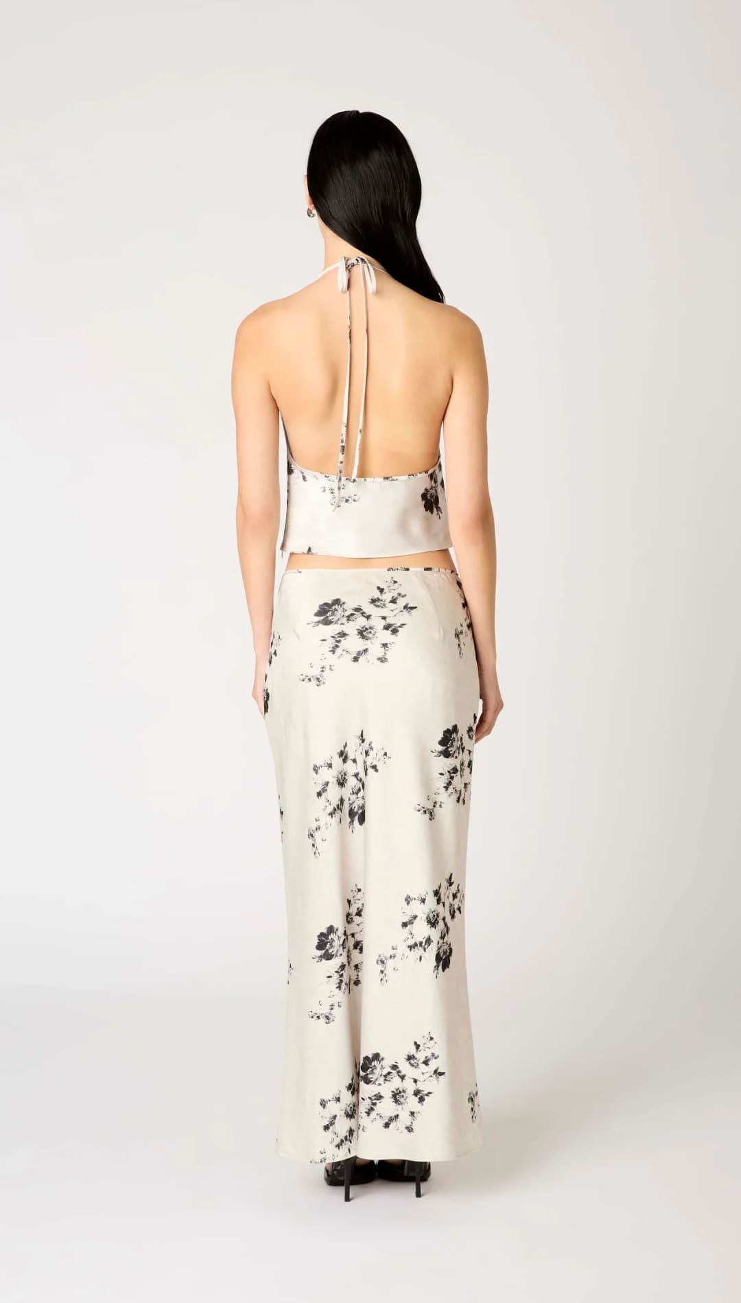 White floral print halter top and skirt set with black accents.