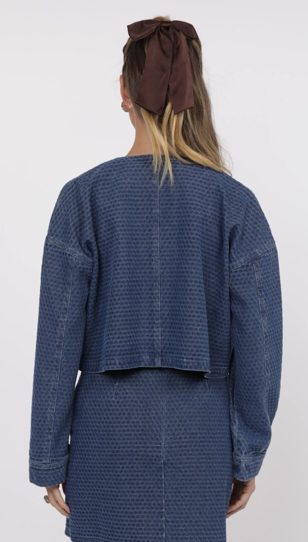 Blue textured jacket and skirt set.