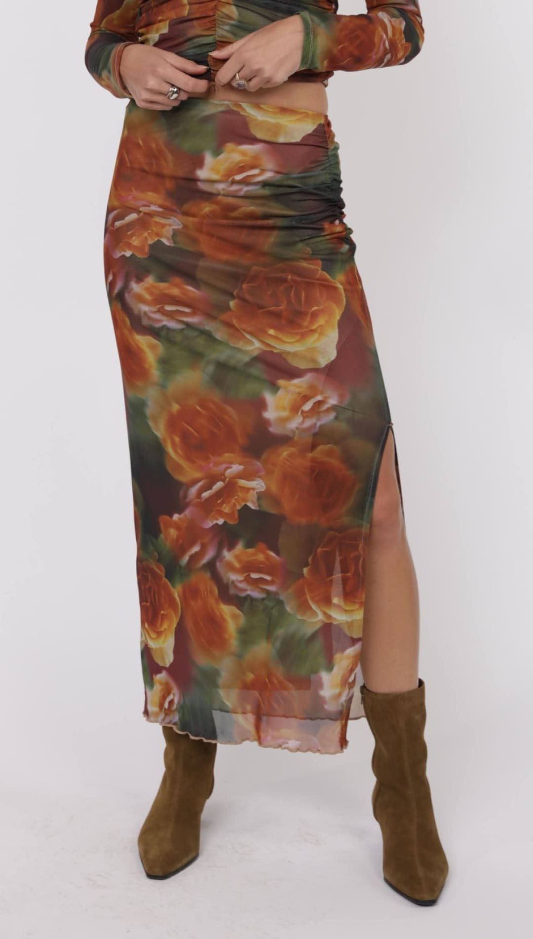 Floral print mesh skirt with a slit.