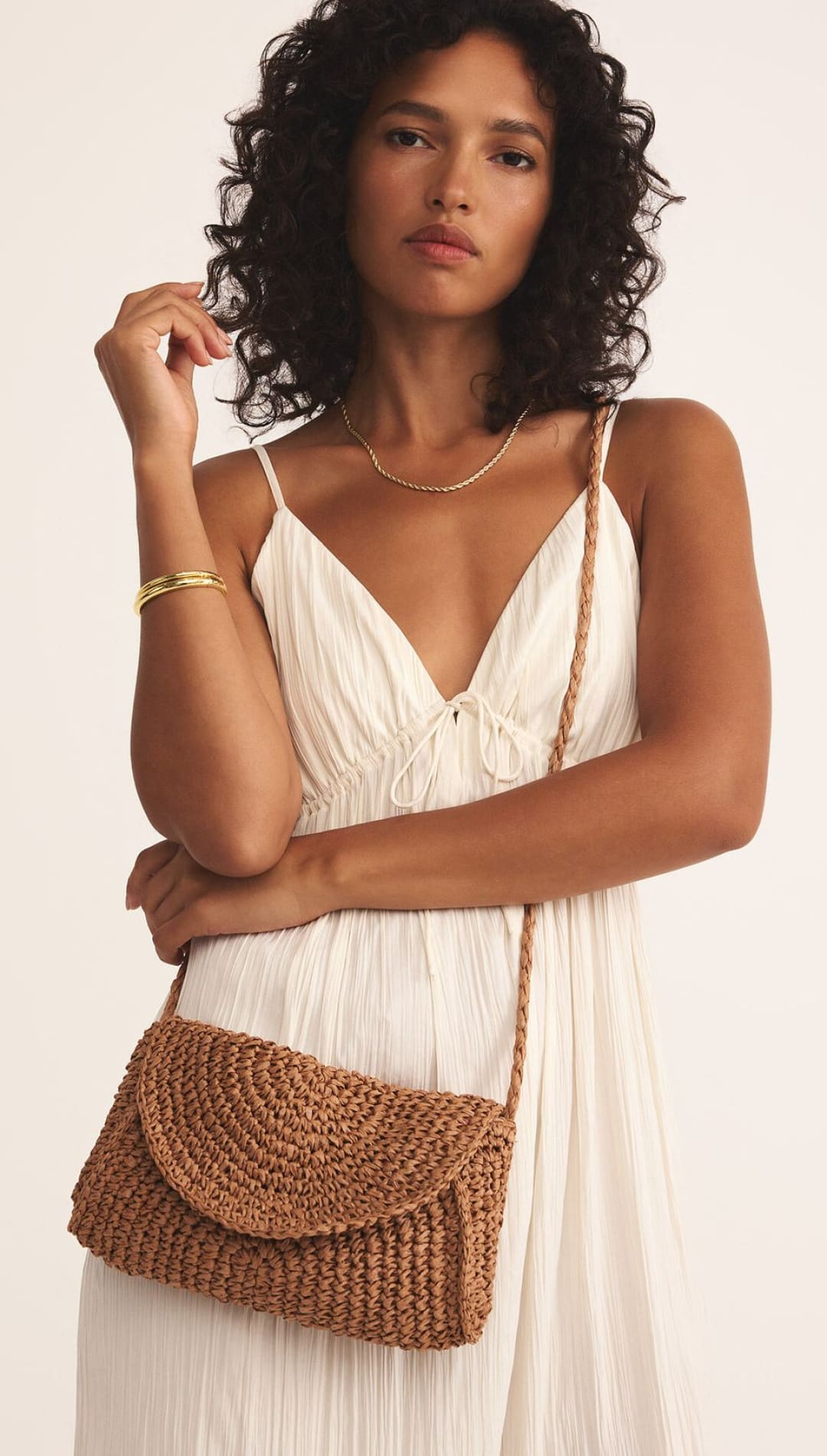 Brown woven crossbody bag.