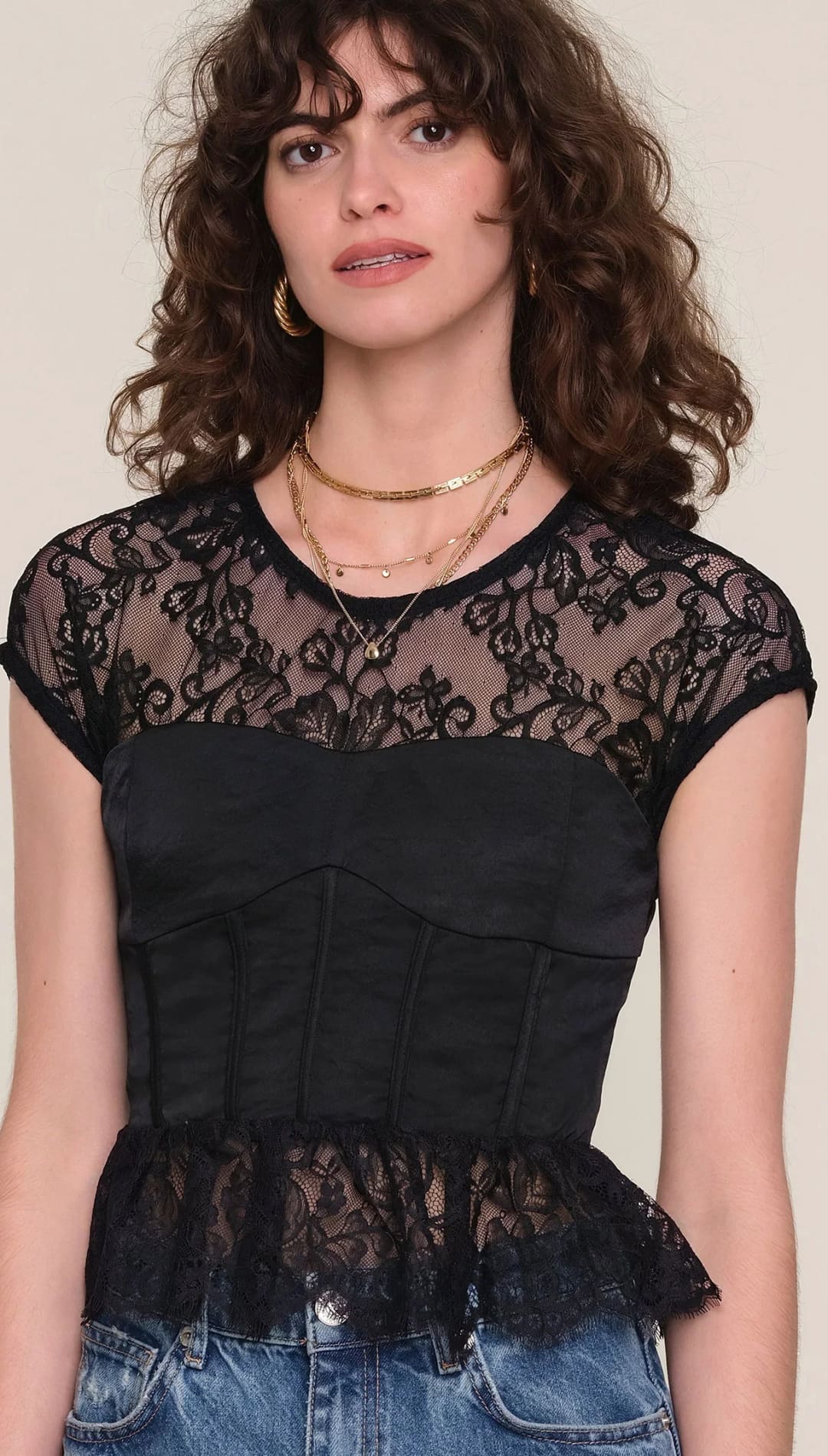 Black lace peplum top with gold chain necklace and jeans.