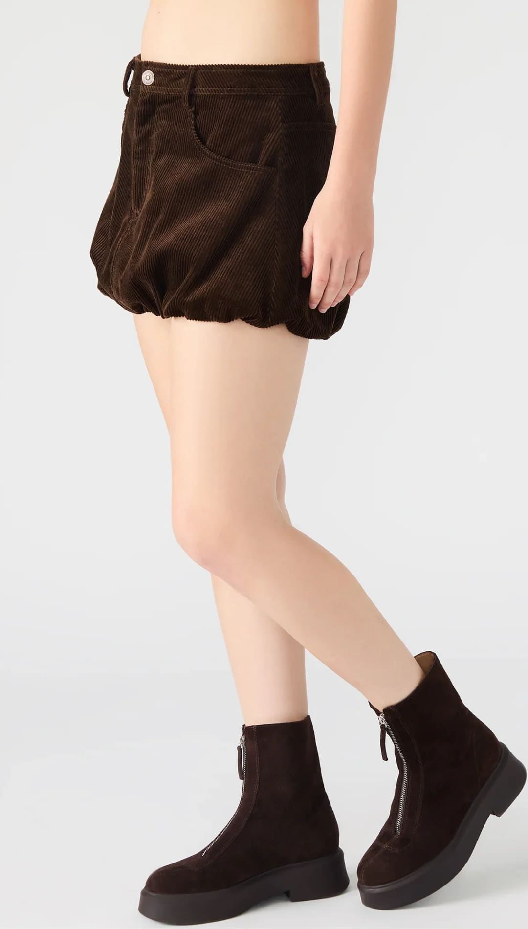 Dark brown corduroy bubble shorts with a front button and zip closure, paired with matching ankle boots with front zippers.