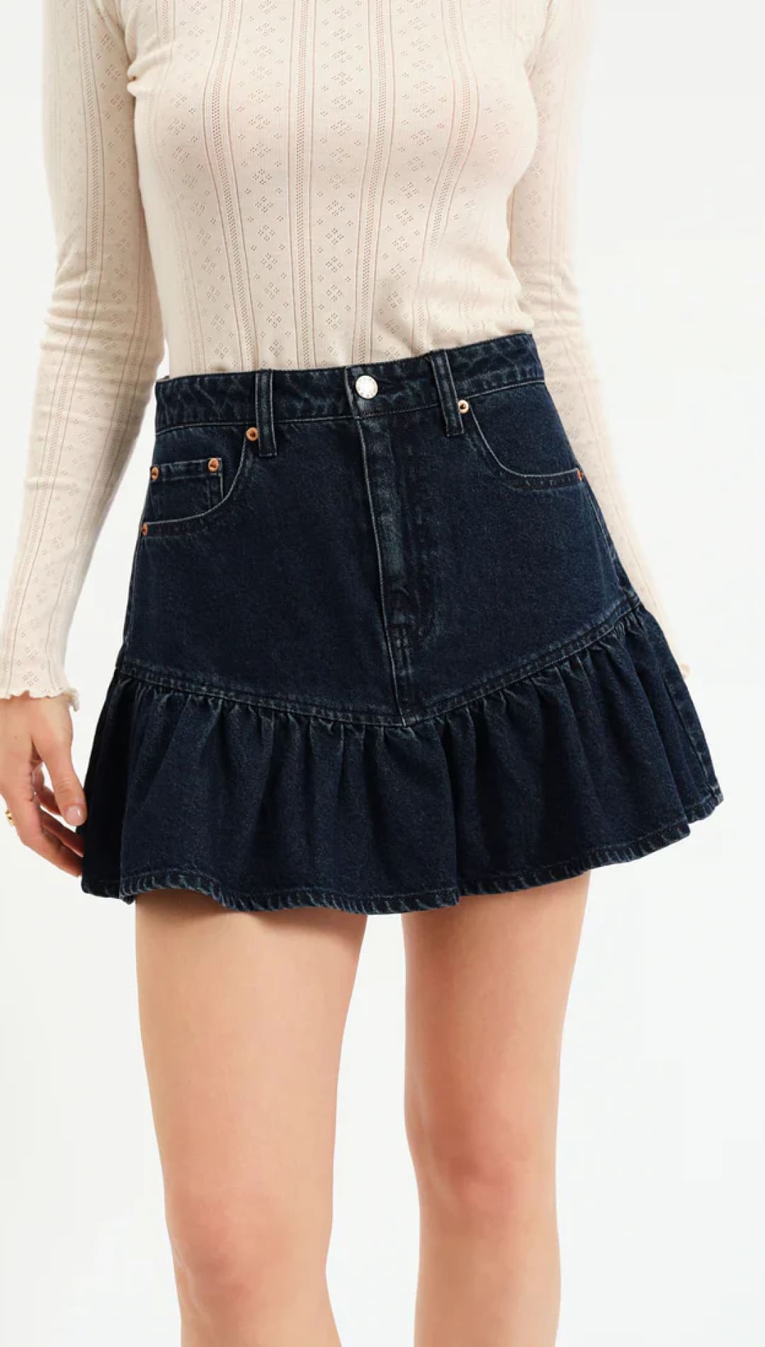 Dark denim ruffled mini skirt with button closure and elastic waistband.