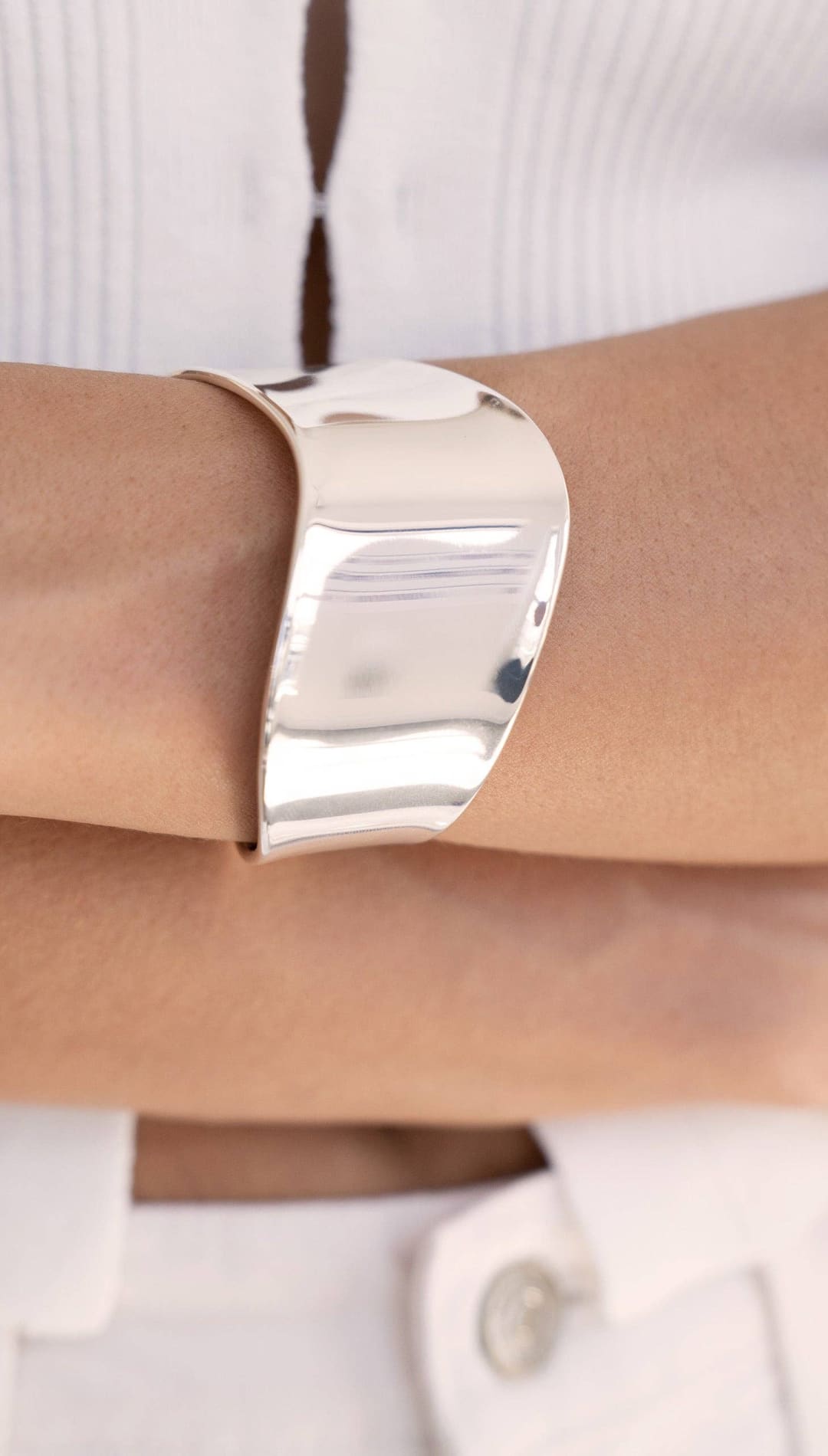 Shiny silver cuff bracelet.