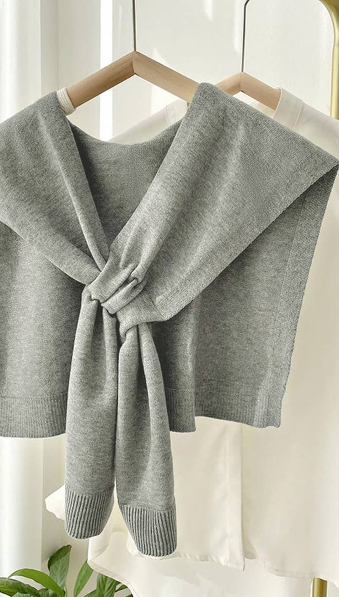 Gray knitted shawl with a bow tie design, suitable for women.