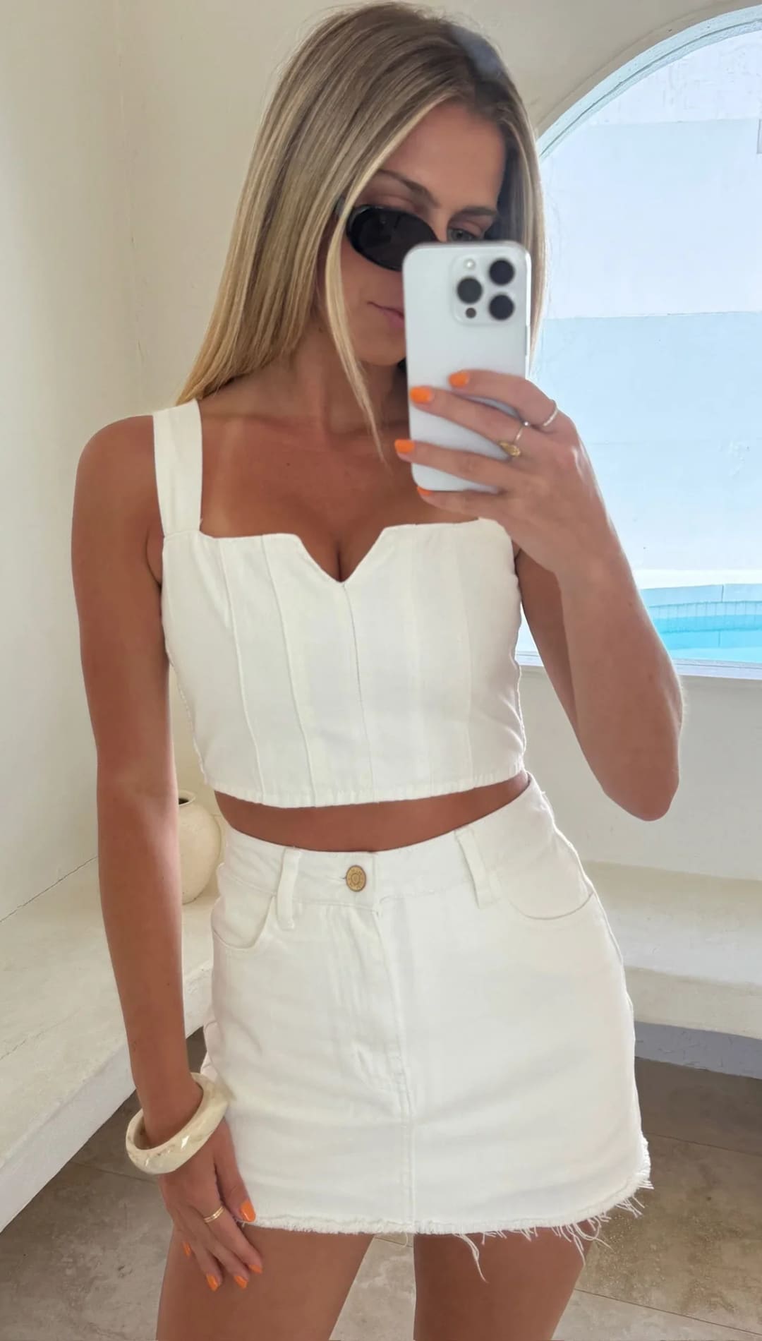 Woman in white two-piece outfit.