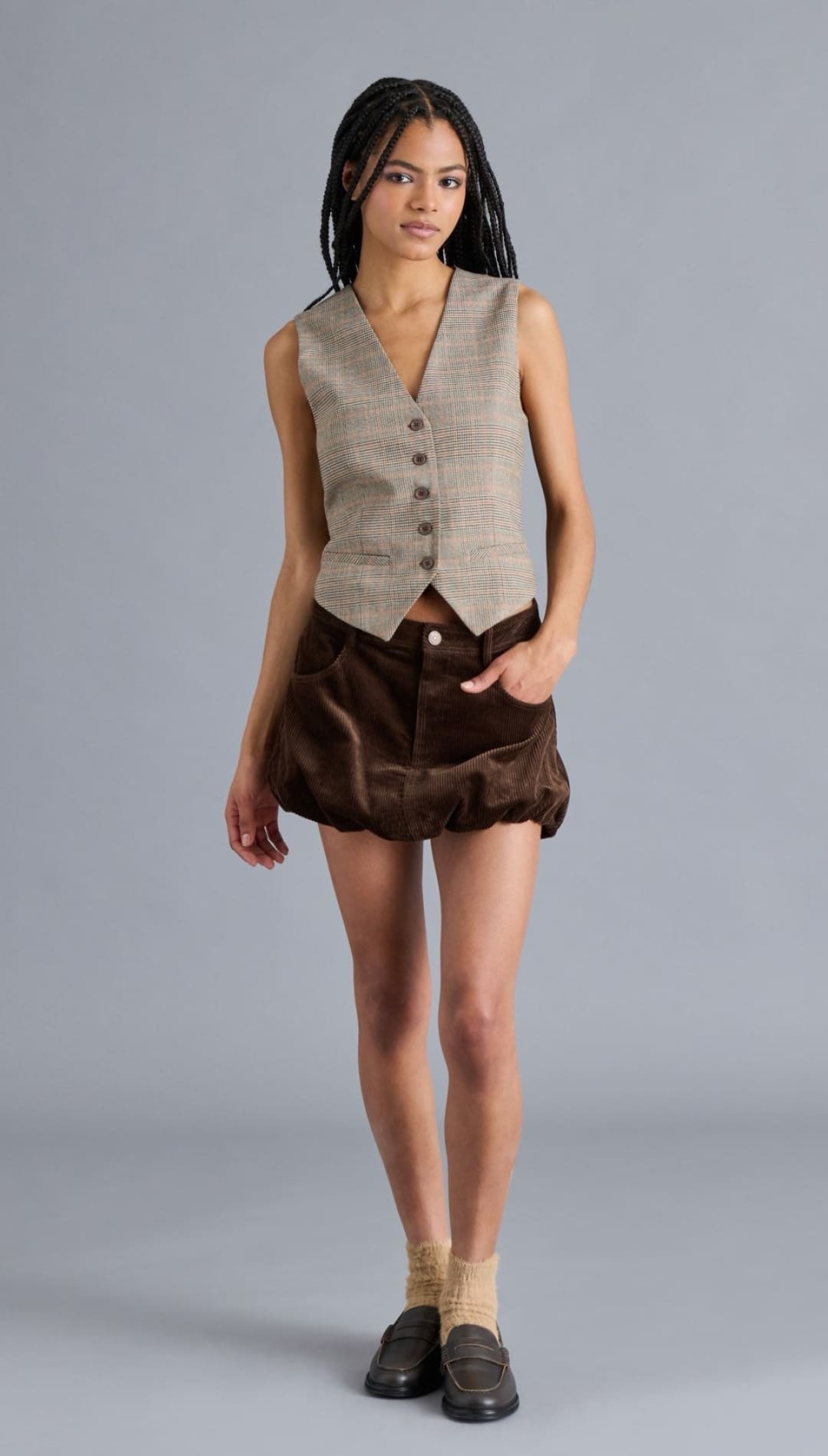 Women’s sleeveless plaid vest with a V-neck and front buttons.