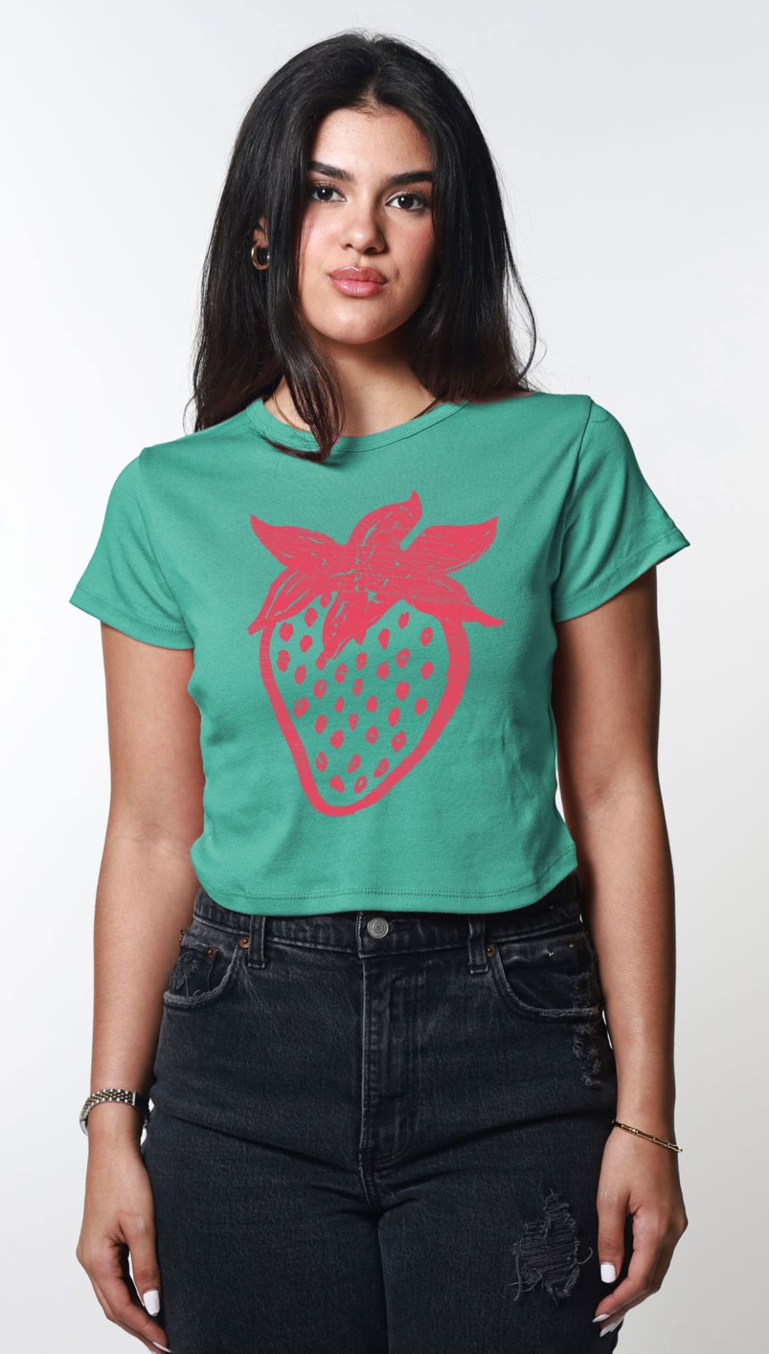 Woman wearing a green t-shirt with a pink strawberry design.