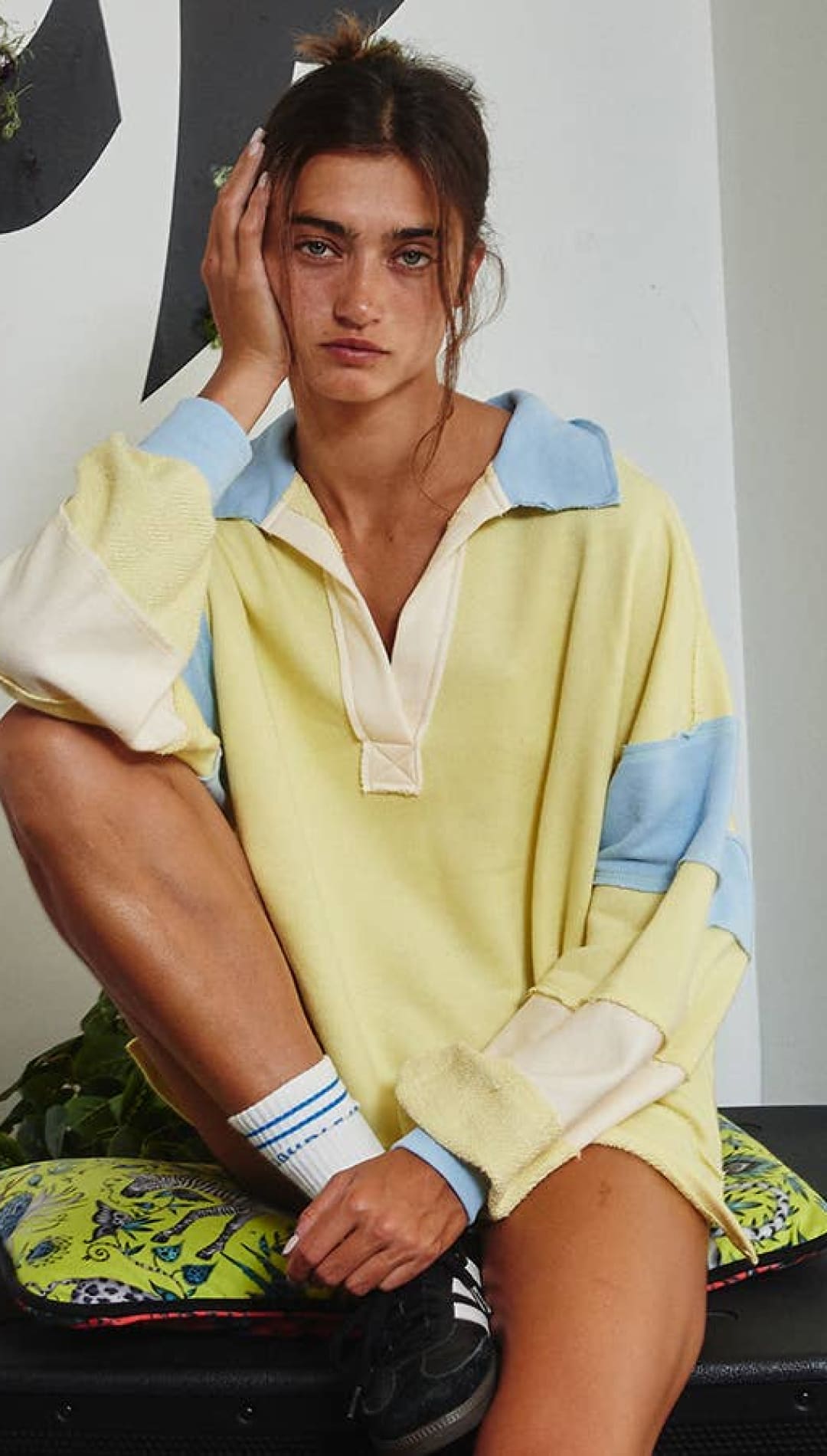 Yellow and white striped polo shirt with blue accents, cotton material.