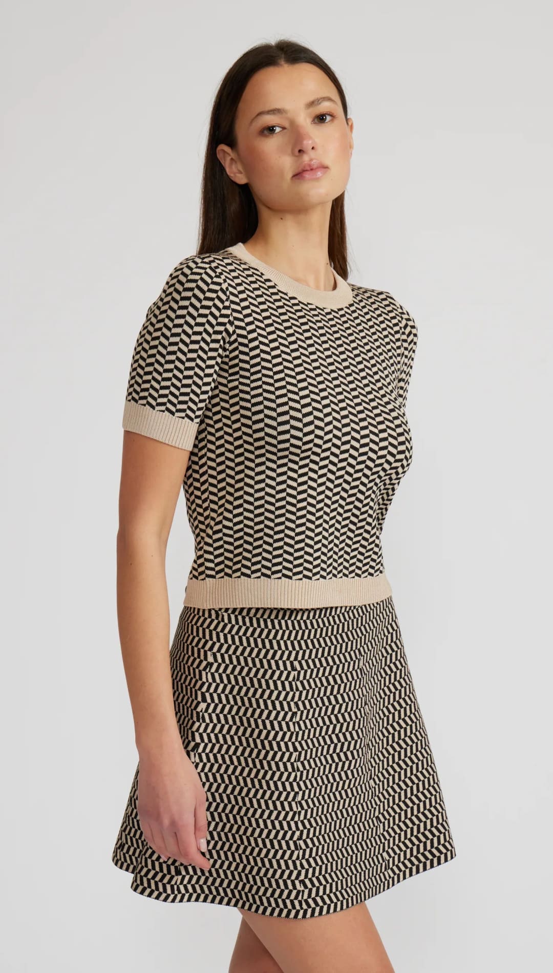 Black and beige chevron print short-sleeved knit top and matching mini skirt.