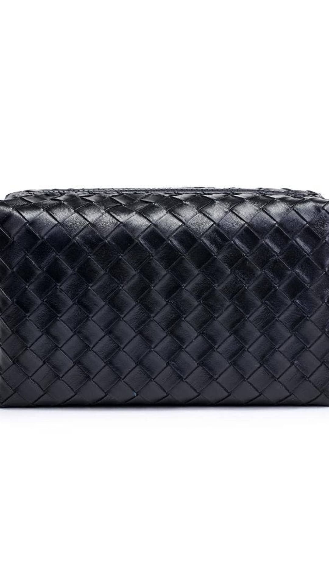Black bottega veneta woven leather toiletry bag with zipper closure.