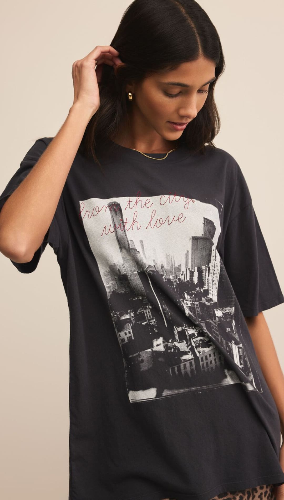 Black graphic tee with cityscape design and ’love the city’ text, featuring a relaxed fit.
