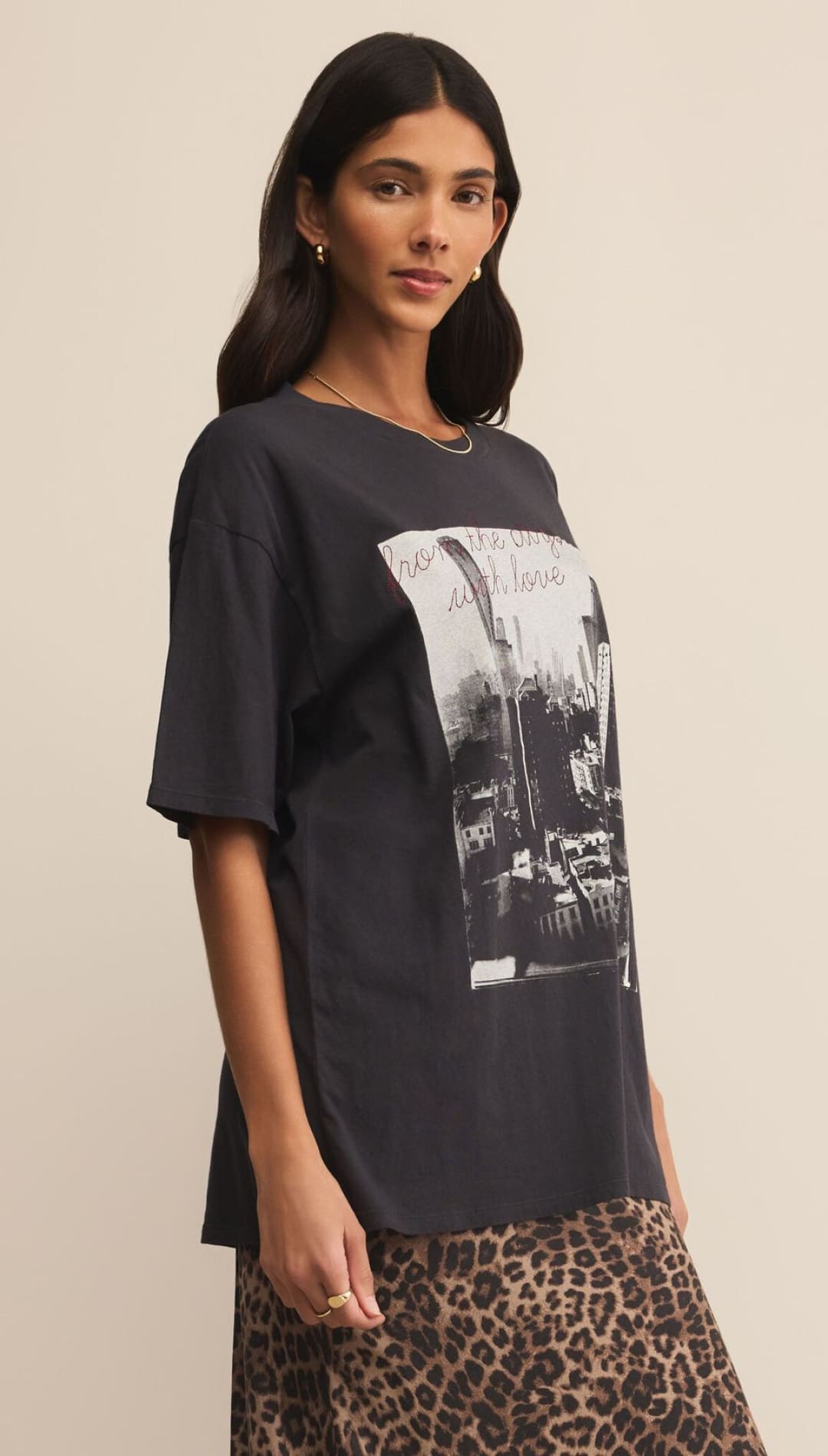 Charcoal graphic tee with black and white cityscape design, leopard print skirt.