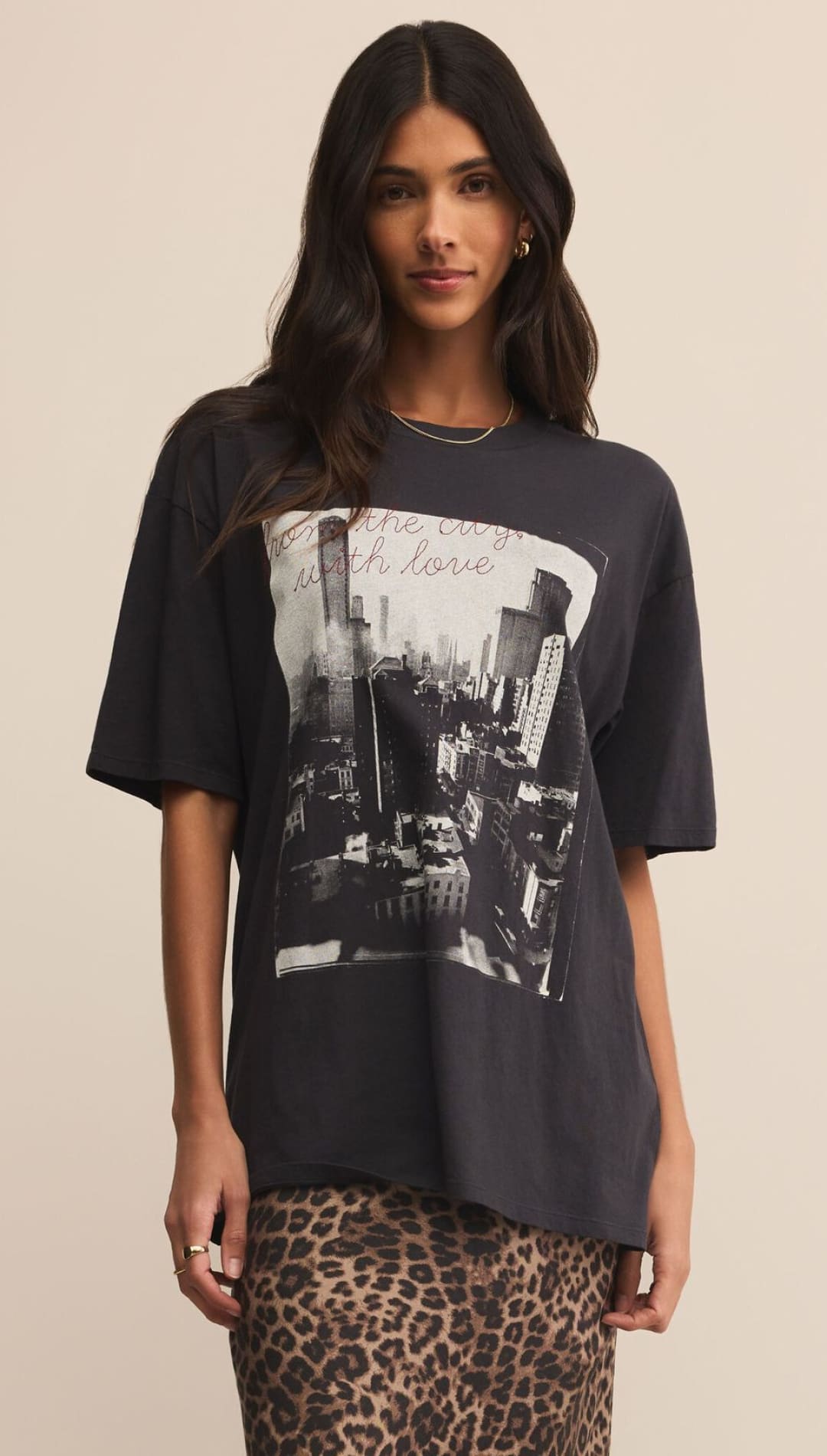 Charcoal oversized graphic tee with cityscape print and ’with love’ text, leopard skirt.