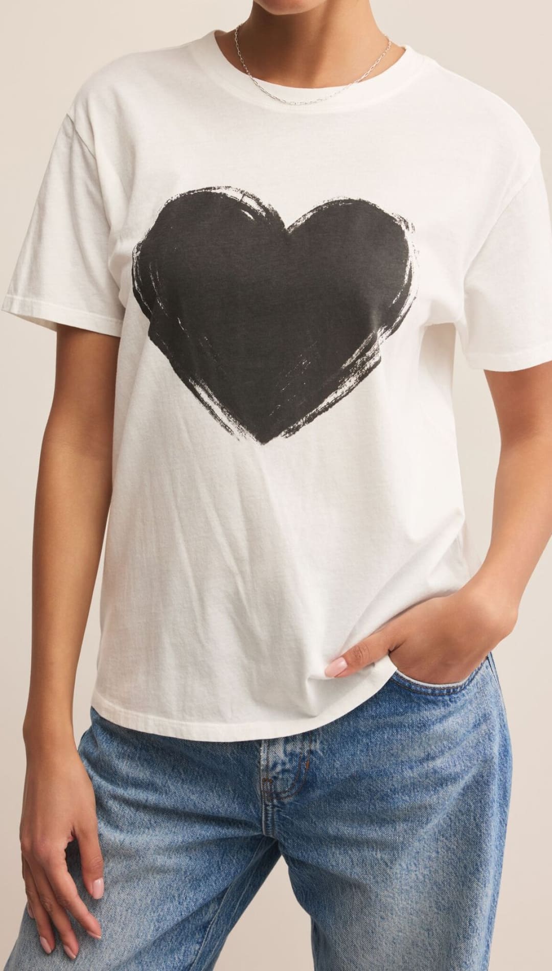 White heart graphic tee with black paintbrush stroke design.