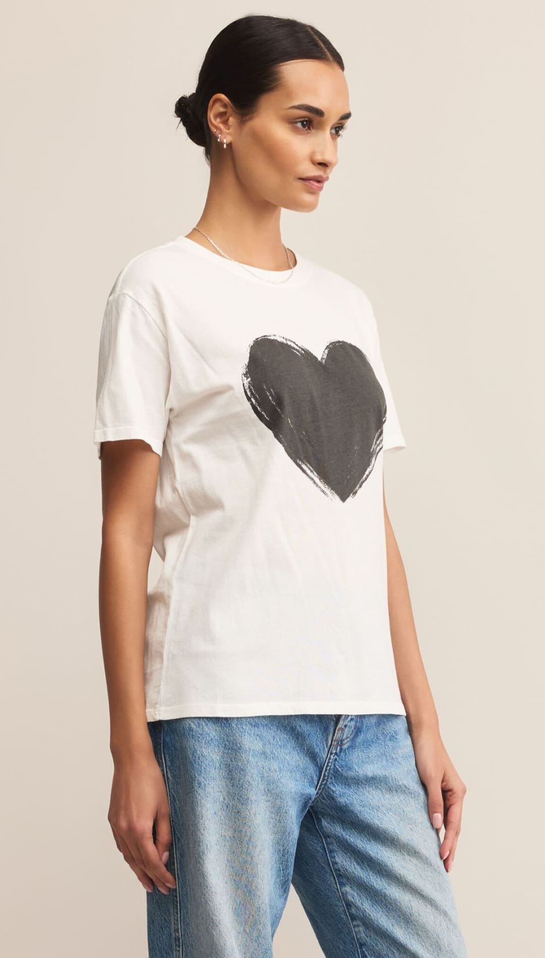 White heart graphic tee shirt with black heart design, casual wear.