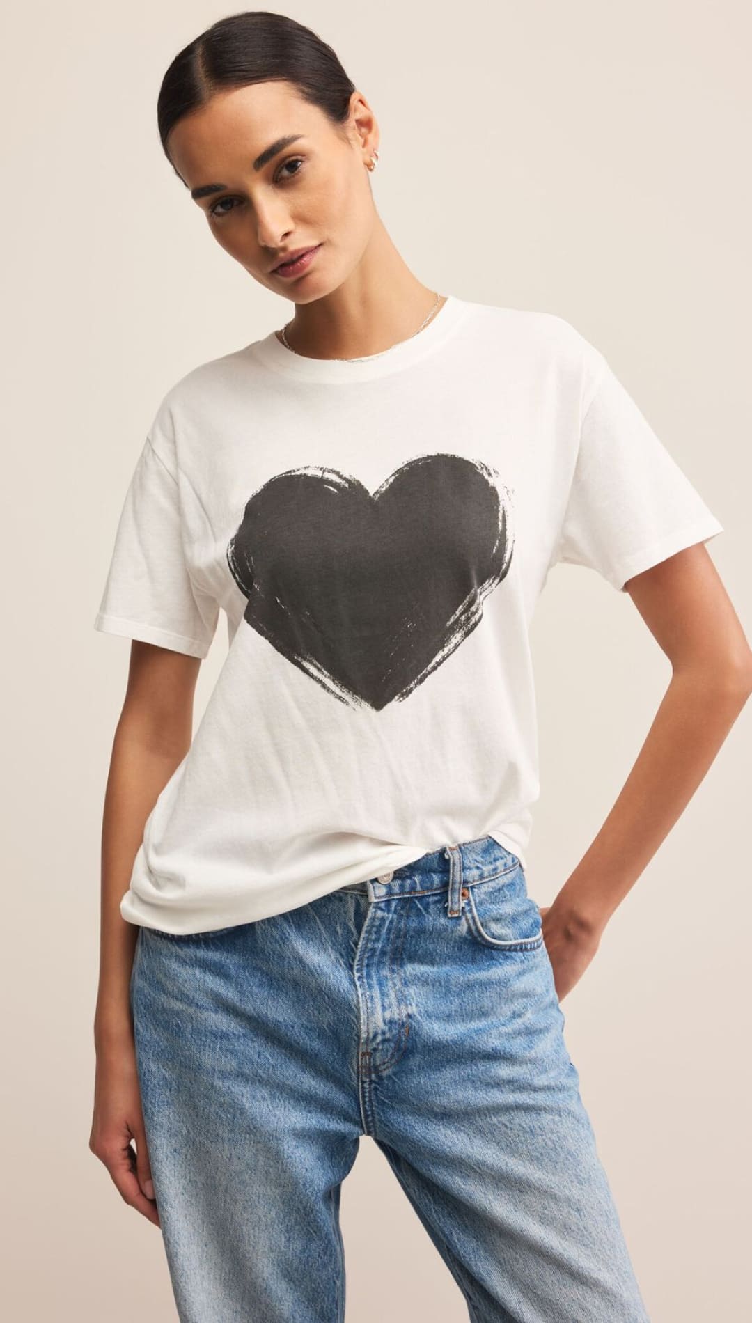 White heart graphic tee with black paintbrush stroke design.