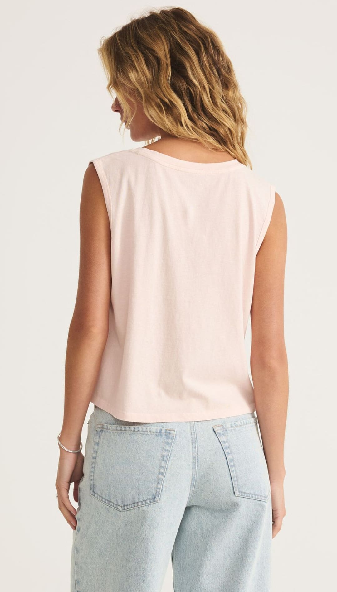 Light pink sleeveless top.