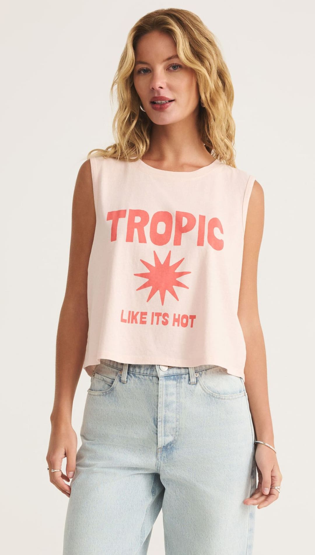 Woman’s graphic tank top and jeans.