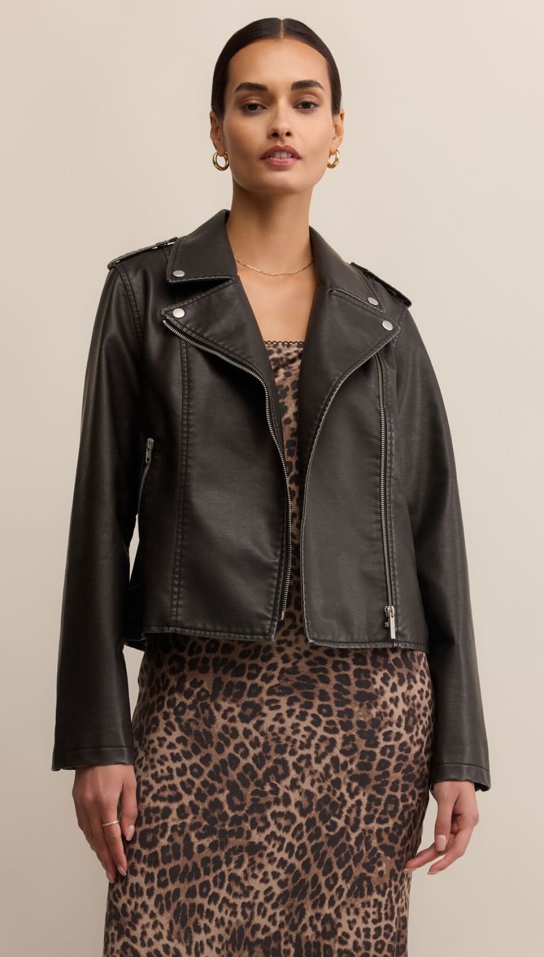 Black leather moto jacket with silver hardware and zipper details.