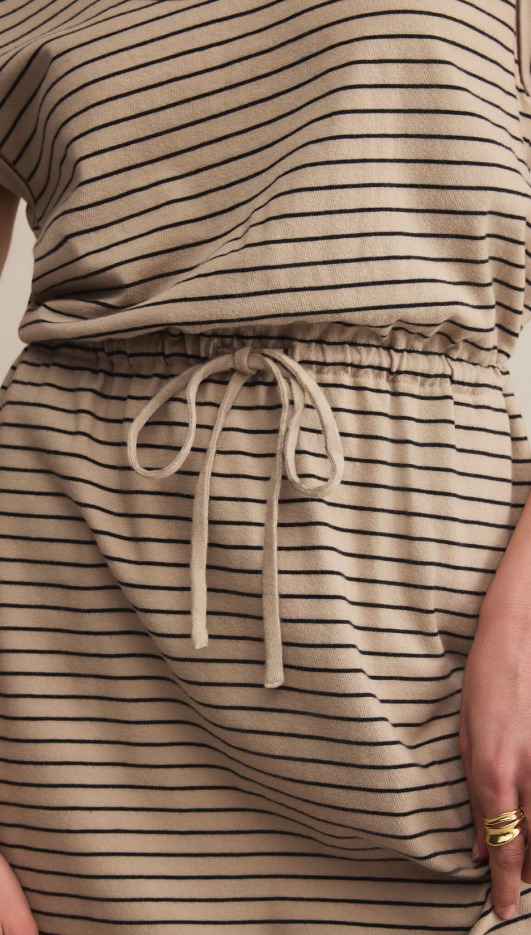 A beige and black striped midi-dress with a drawstring waist.