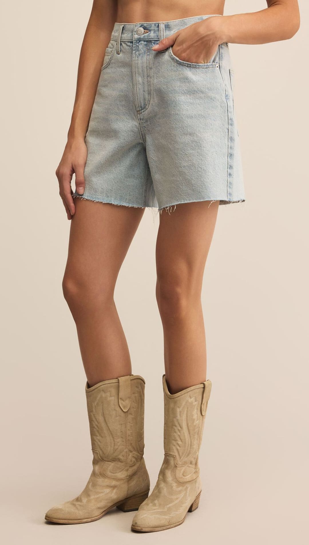 Light wash high-waisted denim shorts with a frayed hem.