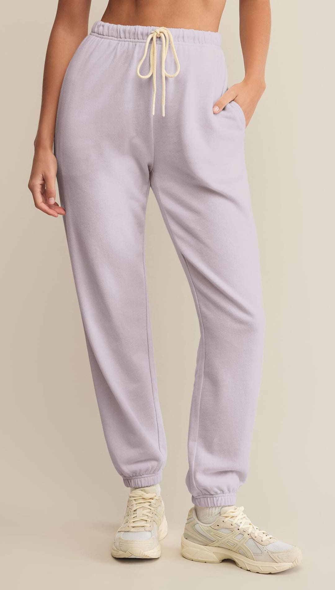 Light purple sweatpants with a cream drawstring.