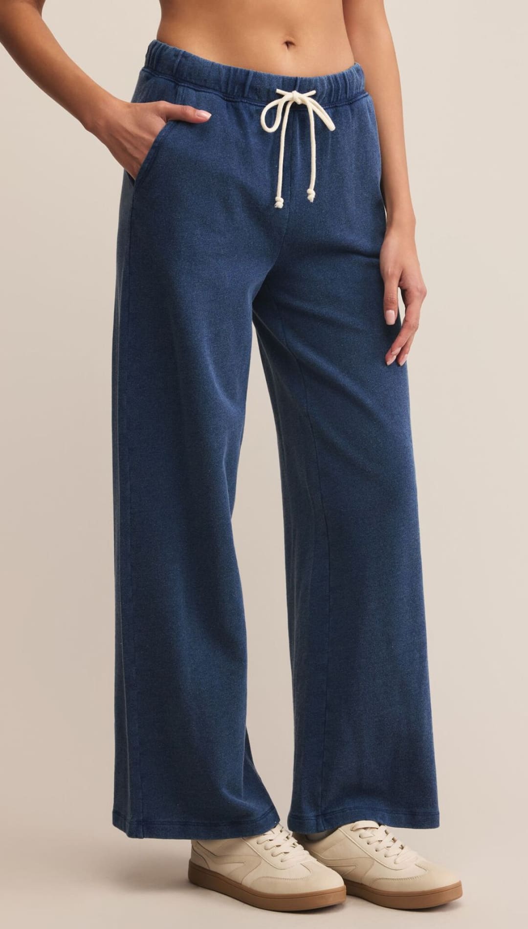 Navy blue wide-leg sweatpants with an elastic waistband and white drawstring.