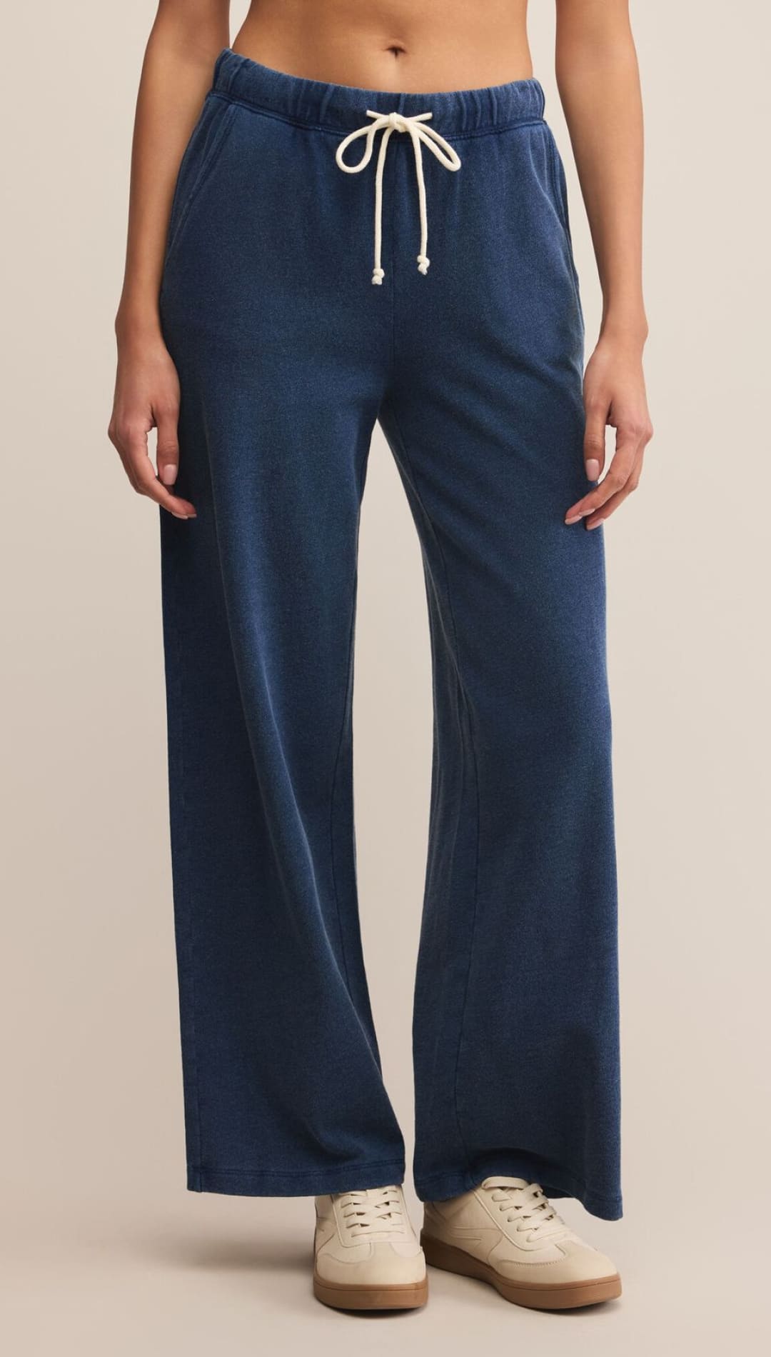 Navy blue wide-leg sweatpants with a white drawstring.